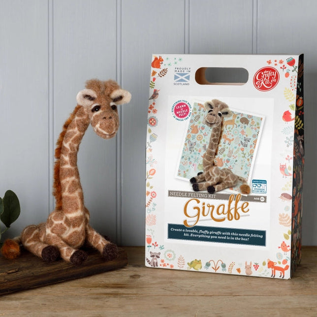NF giraffe next to its packaging on a wooden surface with a grey panelled wall background.