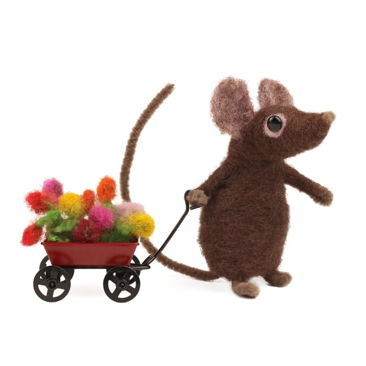 A brown needle felted mouse toy pulling a small red wagon filled with colourful fluffy pom-pom flowers, photographed on a plain white background.
