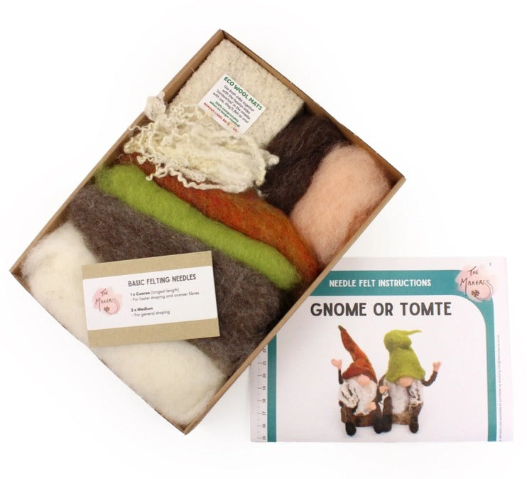 A felt needle kit shown open with multiple wool fibres in cream, brown, green, orange, and pink, alongside a booklet titled 'Needle Felt Instructions' and a card labelled 'Basic Felting Needles' on a white background.