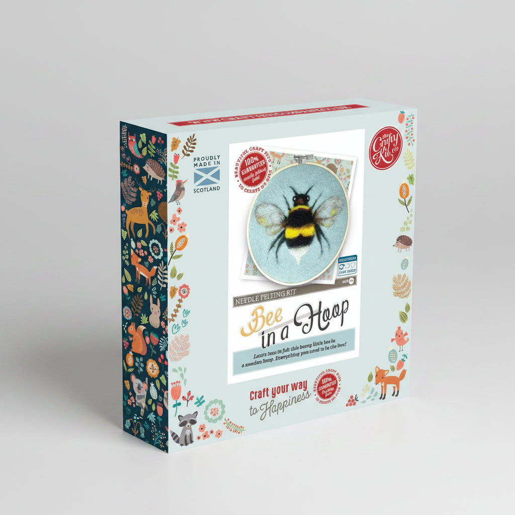 Packaging of a needle felting kit with a bee design on a white background