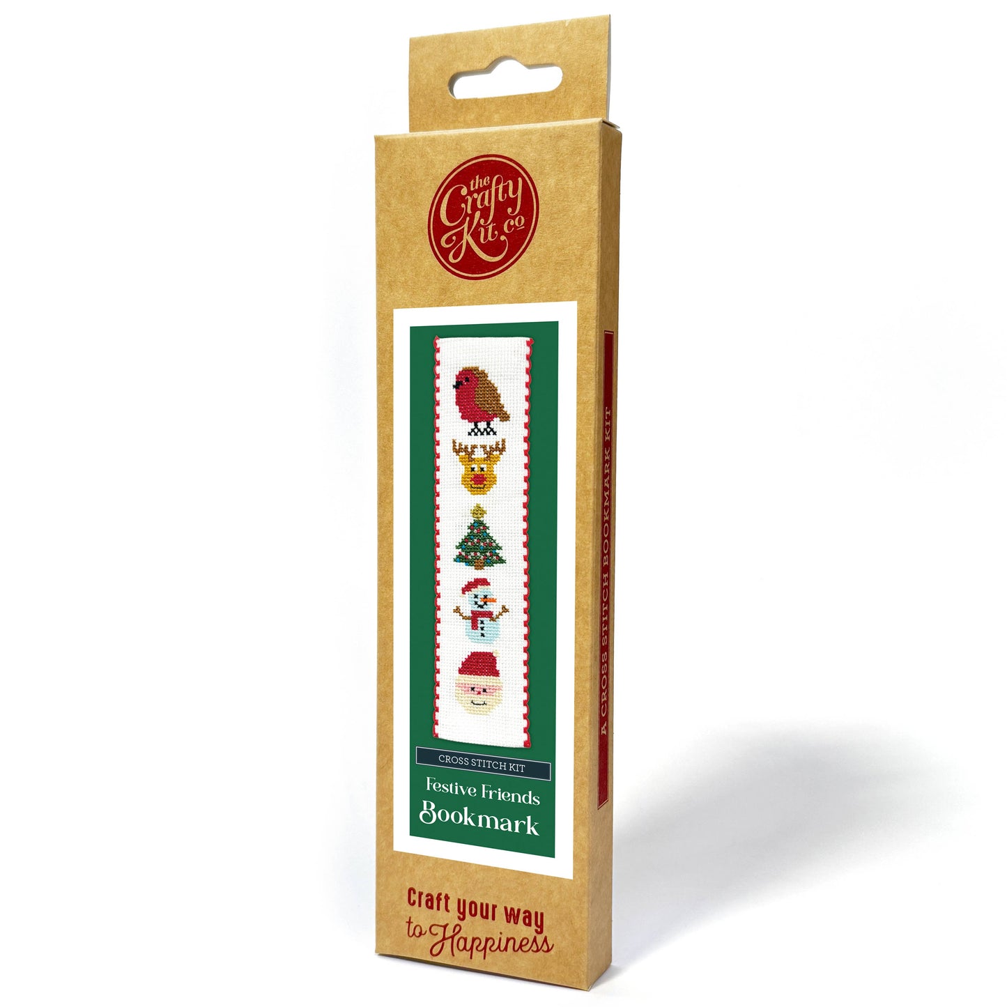 A boxed craft kit package standing upright on a white background. The package is kraft brown cardboard with a hanging tab at the top, a red circular logo near the top, and a central label showing a Christmas-themed bookmark design with a bird, reindeer, gold ornament, Christmas tree, snowman, and Santa.