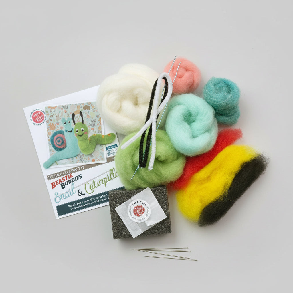 Felted snail and caterpillar craft kit with colourful wool roving on a white wooden surface.