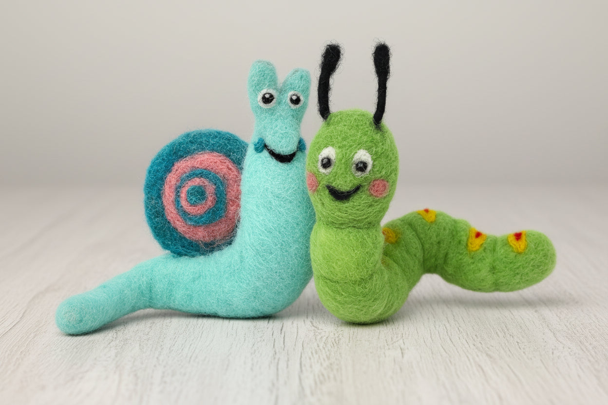 Toy snail and toy caterpillar on a grey background