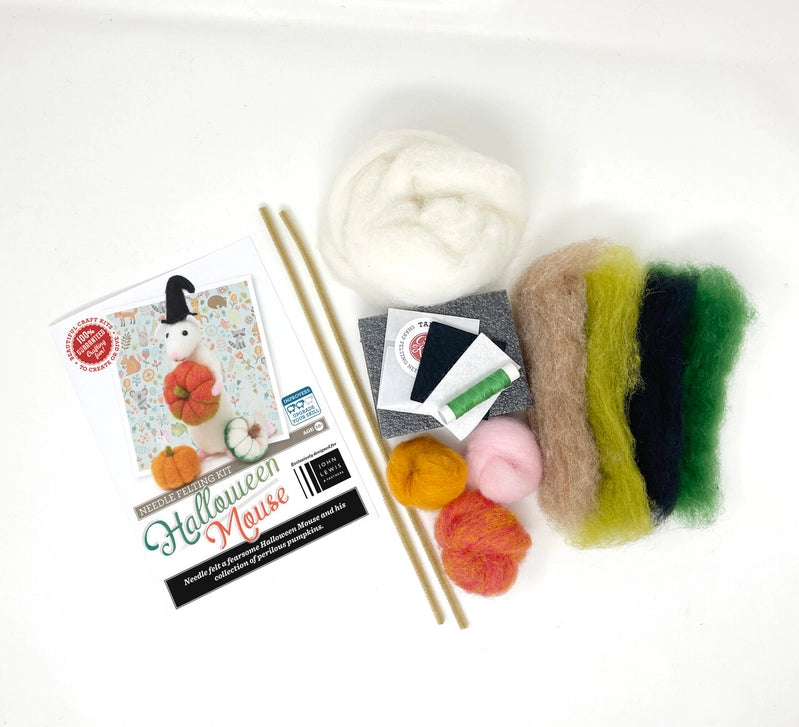 Needle felting supplies including wool, needles, and a box on a white background